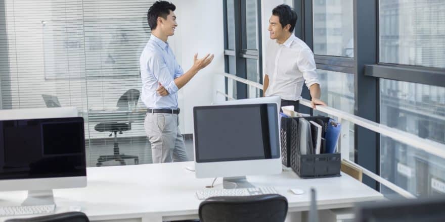 Young Chinese businessmen talking in office